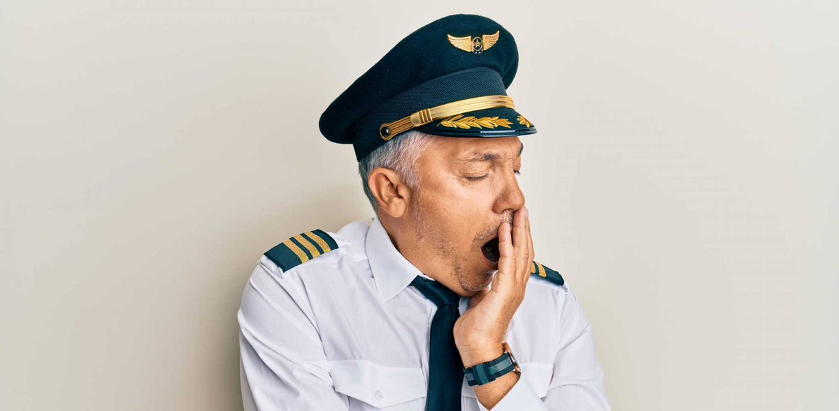 Airline pilot yawning